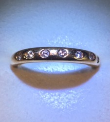 14k YG band with 7 tiny stones